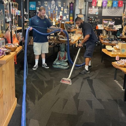 Clean Choice Floor Care technicians extracting a floor